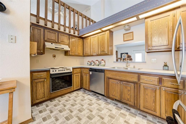 kitchen featuring under cabinet range hood, a sink, light countertops, appliances with stainless steel finishes, and brown cabinets