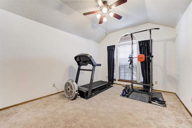 workout room with carpet floors, vaulted ceiling, a textured ceiling, ceiling fan, and baseboards