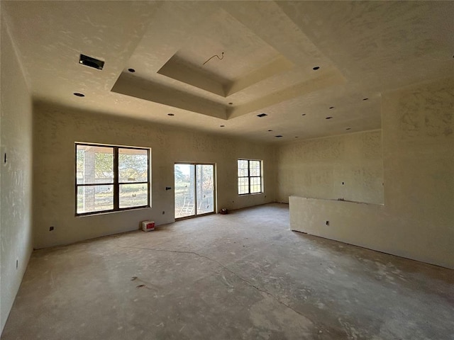 empty room with a tray ceiling and a high ceiling