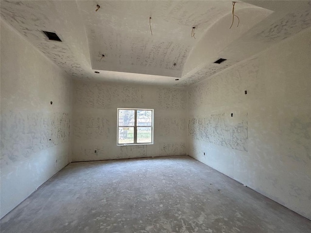 empty room featuring a tray ceiling