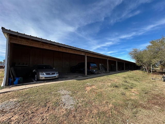 view of car parking with a carport and a yard