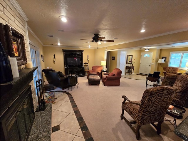 tiled living room with ceiling fan, crown molding, a high end fireplace, and a textured ceiling