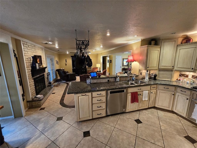 kitchen featuring sink, light tile patterned floors, dishwasher, a fireplace, and kitchen peninsula