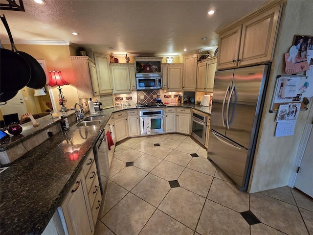 kitchen with light tile patterned flooring, sink, dark stone counters, stainless steel appliances, and decorative backsplash