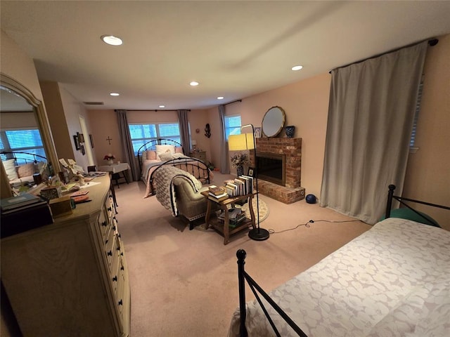 carpeted bedroom with a brick fireplace