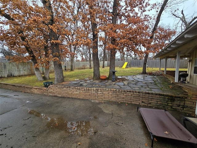 view of yard featuring a patio and a playground