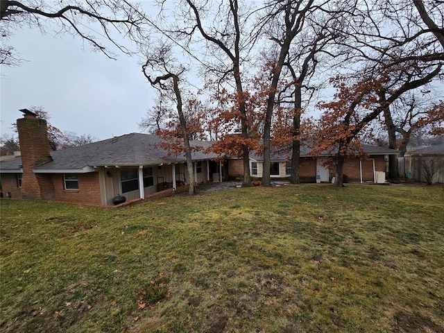 rear view of property featuring a yard