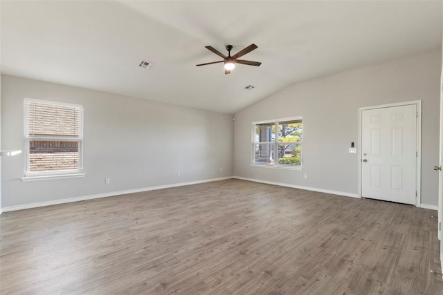 unfurnished room featuring light hardwood / wood-style flooring, ceiling fan, and vaulted ceiling