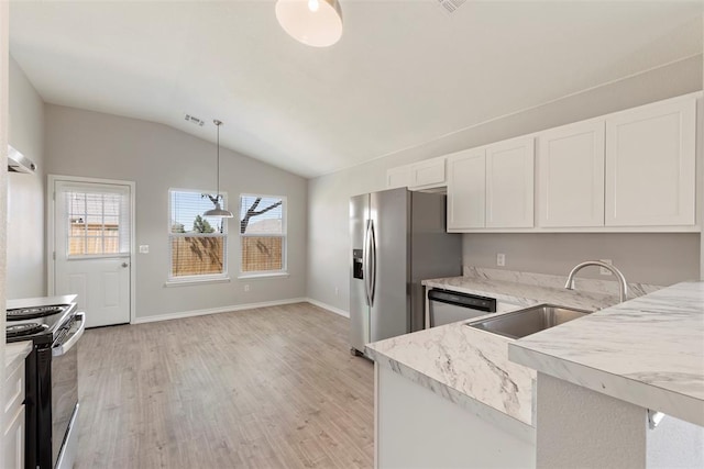 kitchen with pendant lighting, sink, lofted ceiling, white cabinetry, and stainless steel appliances