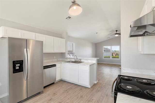 kitchen featuring wall chimney range hood, sink, stainless steel appliances, light stone countertops, and white cabinets