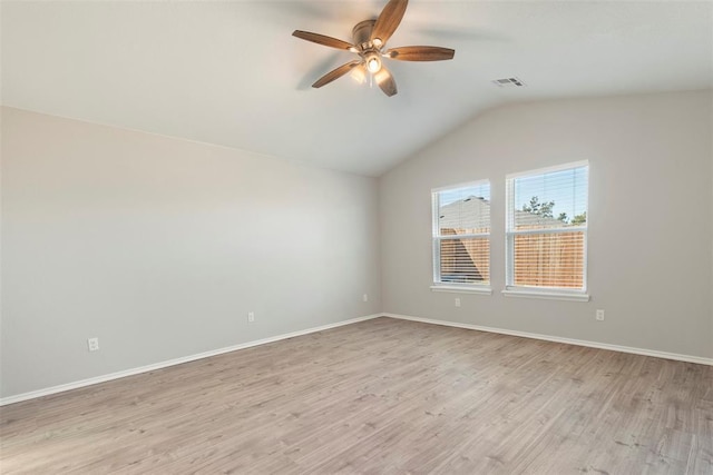 empty room with ceiling fan, lofted ceiling, and light hardwood / wood-style floors