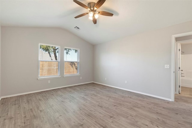 empty room with lofted ceiling, light hardwood / wood-style flooring, and ceiling fan