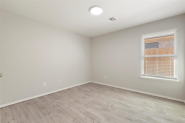 spare room featuring light hardwood / wood-style floors