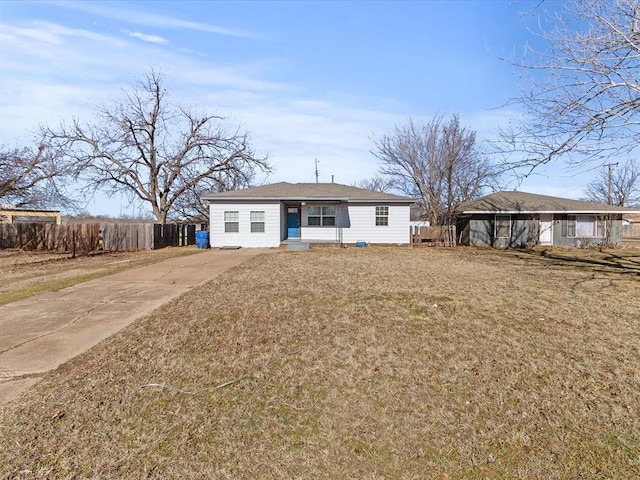 rear view of house featuring a carport and a yard