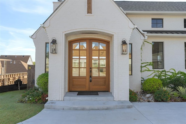 view of exterior entry featuring french doors