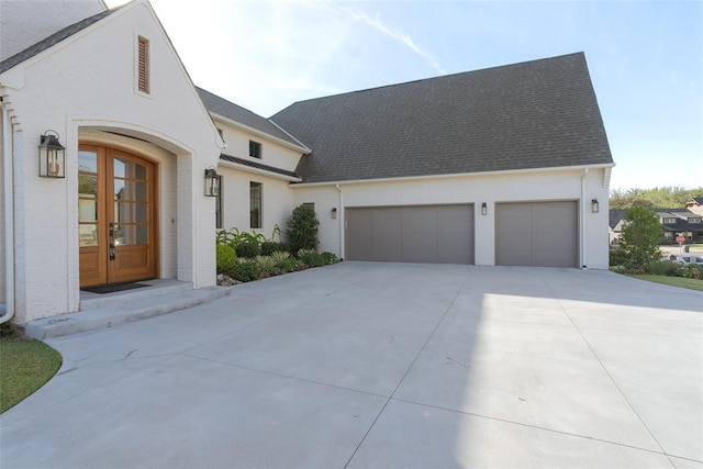 view of front facade with french doors and a garage