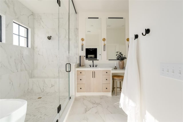 bathroom with vanity and a shower with door