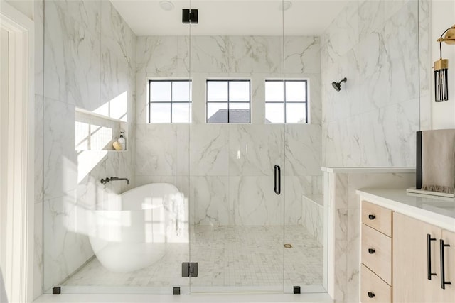 bathroom with vanity and separate shower and tub