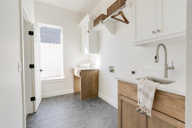 laundry area with sink, hookup for a washing machine, cabinets, dark parquet floors, and hookup for an electric dryer