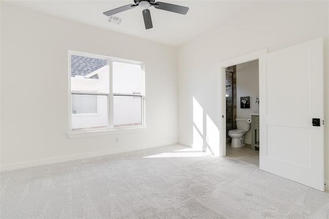 unfurnished bedroom with light carpet, ceiling fan, and ensuite bathroom