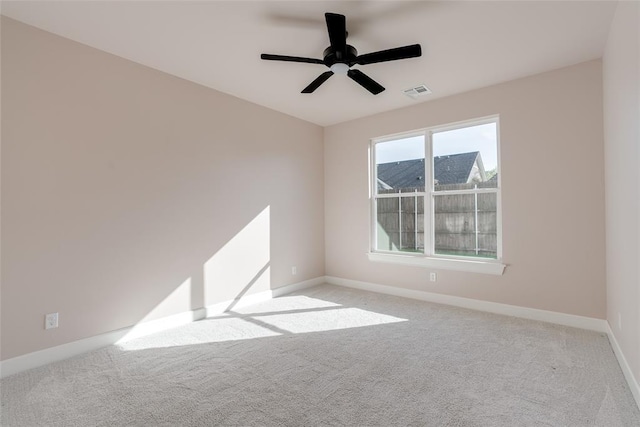 carpeted spare room featuring ceiling fan