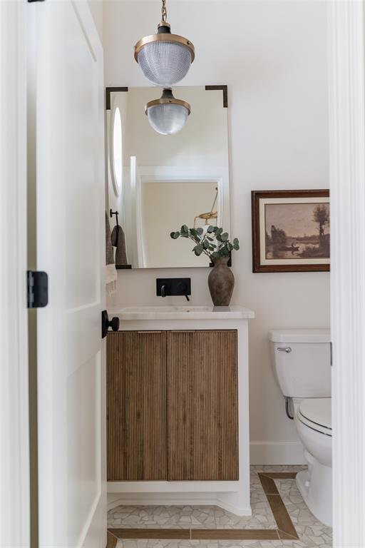 bathroom featuring vanity and toilet