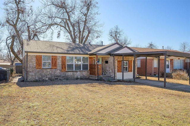 ranch-style home with a carport and a front lawn