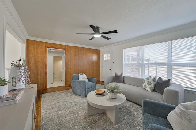 living room featuring crown molding, ceiling fan, and hardwood / wood-style floors