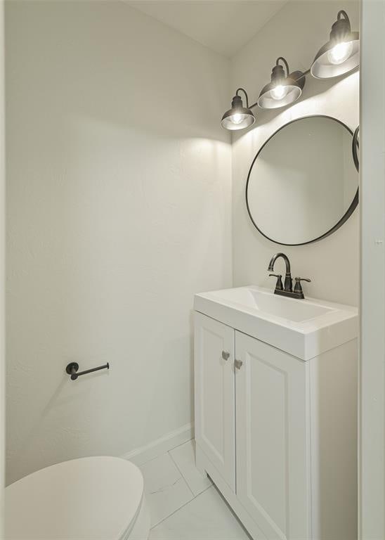 bathroom featuring vanity and toilet