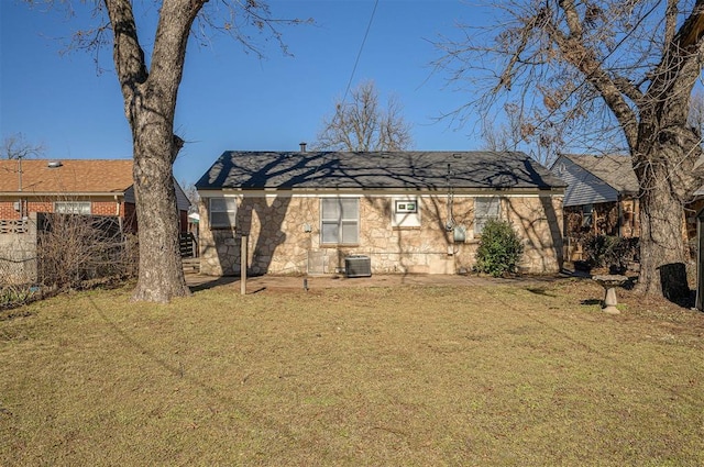 back of house with a yard and central air condition unit