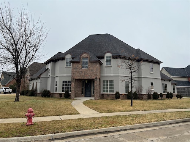 french country style house featuring a front lawn