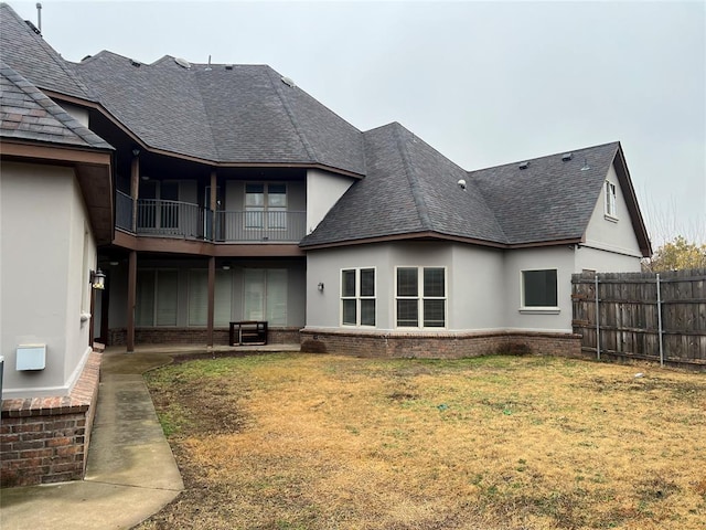 rear view of property featuring a lawn