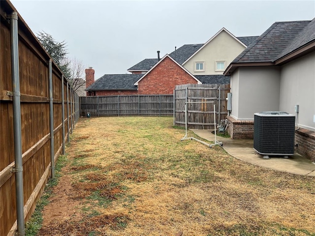 view of yard featuring central AC and a patio