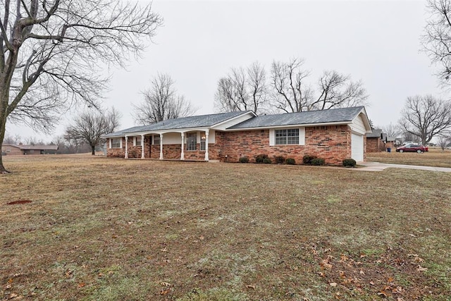 ranch-style house with a garage, a porch, and a front lawn