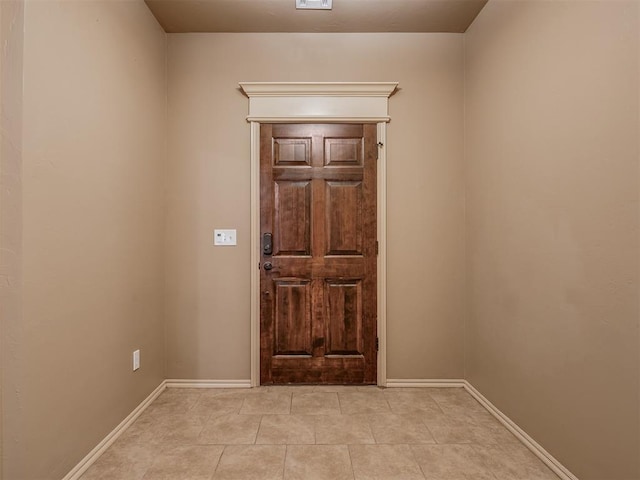 entryway with light tile patterned floors