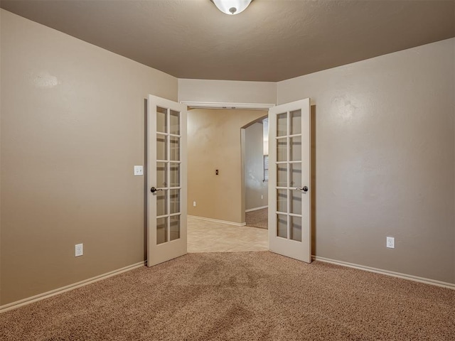 empty room with light carpet and french doors