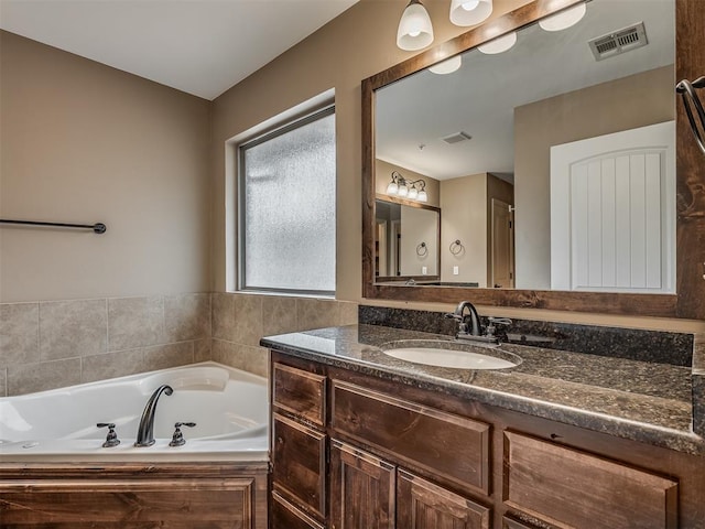 bathroom featuring vanity and a bathtub