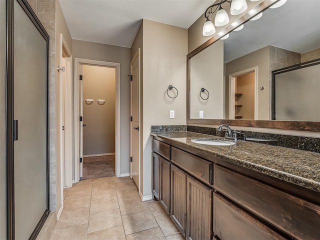 bathroom featuring vanity, tile patterned flooring, and a shower with door