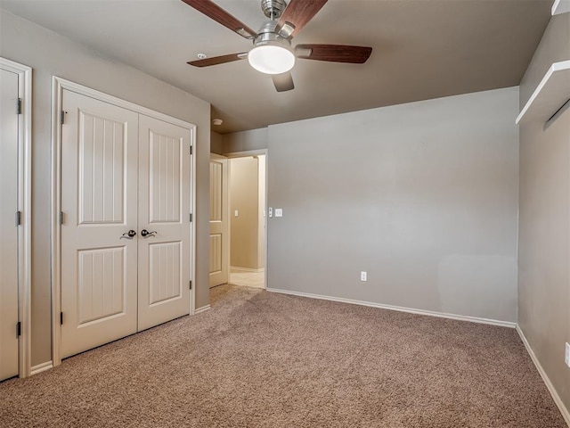 unfurnished bedroom with ceiling fan, carpet flooring, and a closet