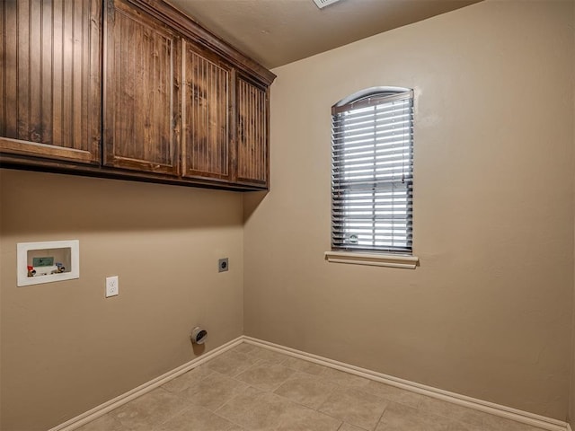 washroom with cabinets, a wealth of natural light, electric dryer hookup, and washer hookup