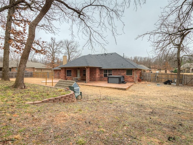 rear view of property featuring a patio and a lawn