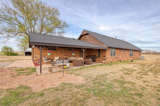 rear view of property featuring an outdoor hangout area, central AC unit, a patio area, and a lawn