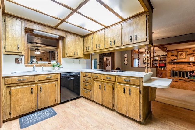 kitchen featuring kitchen peninsula, sink, ceiling fan, black appliances, and light hardwood / wood-style flooring