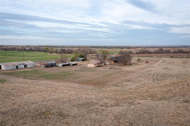 birds eye view of property with a rural view