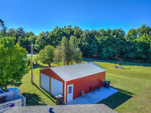 view of outbuilding featuring a garage and a lawn