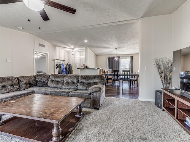 carpeted living room featuring ceiling fan, lofted ceiling, and a textured ceiling