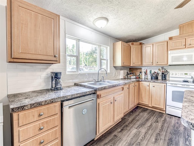 kitchen with lofted ceiling, sink, dark wood-type flooring, light brown cabinets, and white appliances