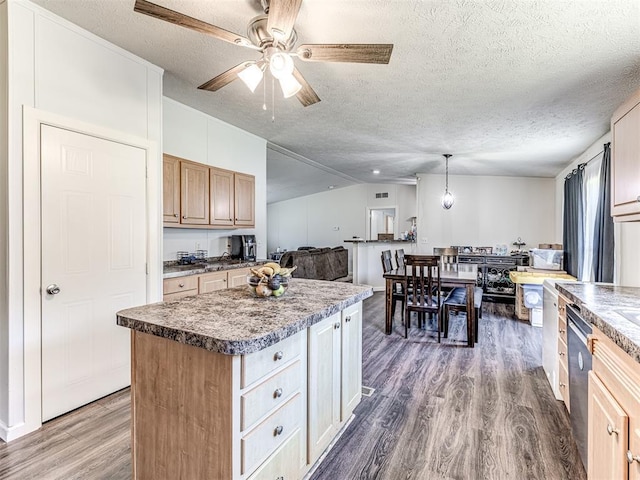 kitchen featuring lofted ceiling, decorative light fixtures, a center island, dark hardwood / wood-style flooring, and dishwasher