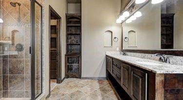 bathroom with vanity and a shower with shower door