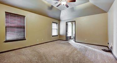 carpeted spare room featuring ceiling fan and lofted ceiling